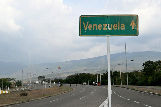 A Venezuela road sign is pictured near the Colombia-Venezuela border checkpoint at the Atanasio Girardot International Bridge on the outskirts of Cucuta, Colombia, taken on March 12, 2026. The first foreign visit of Venezuela's US-backed interim leader, Delcy Rodriguez, since taking power was abruptly cancelled on March 12, 2026, just hours before she was due to arrive in Colombia, a Colombian foreign ministry source told AFP. (Photo by Luis ACOSTA / AFP)