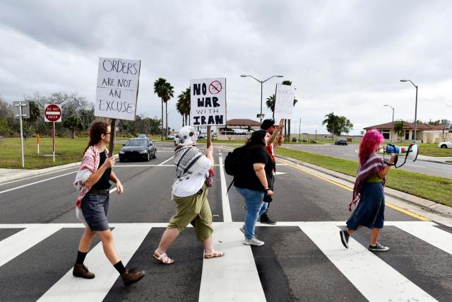 Demonstrators hold signs and shout slogans during a protest to call for "an end to the imperialist violence" amid the ongoing war in Iran outside MacDill Air Force Base, where US Central Command is headquartered, in Tampa, Florida, on March 12, 2026. (Photo by Octavio JONES / AFP)