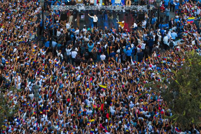This aerial view shows Venezuelan opposition leader Maria Corina Machado speaking to Venezuelans living in Chile at Almagro Square in Santiago on March 12, 2026. Machado travelled to Chile to attend Chile's President Jose Antonio Kast's inauguration. (Photo by Javier TORRES / AFP)