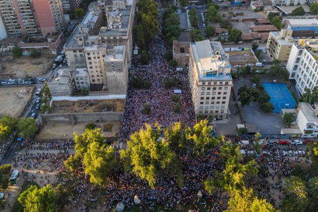 This aerial view shows Venezuelans living in Chile listening to Venezuelan opposition leader Maria Corina Machado at Almagro Square in Santiago on March 12, 2026. Machado travelled to Chile to attend Chile's President Jose Antonio Kast's inauguration. (Photo by Javier TORRES / AFP)