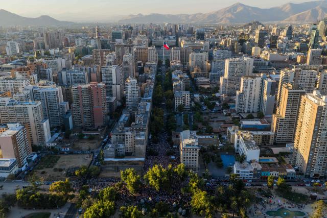 This aerial view shows Venezuelans living in Chile listening to Venezuelan opposition leader Maria Corina Machado at Almagro Square in Santiago on March 12, 2026. Machado travelled to Chile to attend Chile's President Jose Antonio Kast's inauguration. (Photo by Javier TORRES / AFP)