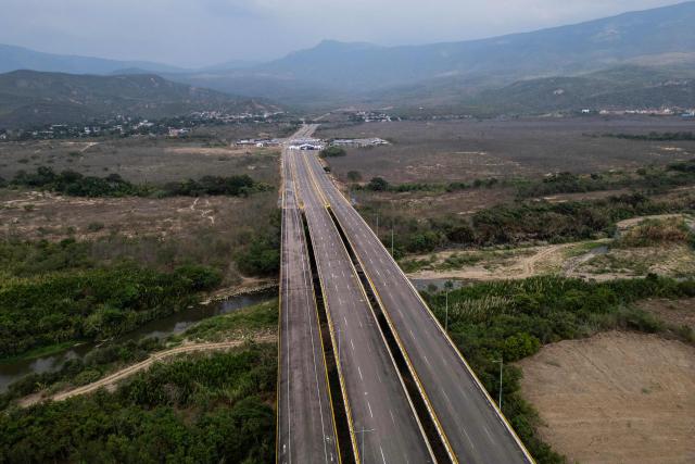 This aerial view shows the Atanasio Girardot International Bridge on the Colombia-Venezuela border, where a stage was dismantled for an encounter between Colombia's President Gustavo Petro and Venezuela's interim President Delcy Rodriguez on the outskirts of Cucuta, Colombia, on March 12, 2026. The first foreign visit of Venezuela's US-backed interim leader, Delcy Rodriguez, since taking power was abruptly cancelled on March 12, 2026, just hours before she was due to arrive in Colombia, a Colombian foreign ministry source told AFP. (Photo by Luis ACOSTA / AFP)