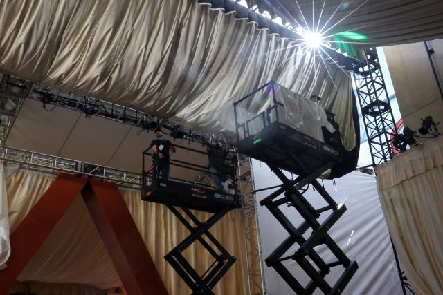 Workers on a scissor lift install lights as preparations are made on the carpet arrivals area ahead of the 98th Annual Academy Awards outside the Dolby Theatre in Hollywood, California, on March 12, 2026. (Photo by ANGELA WEISS / AFP)