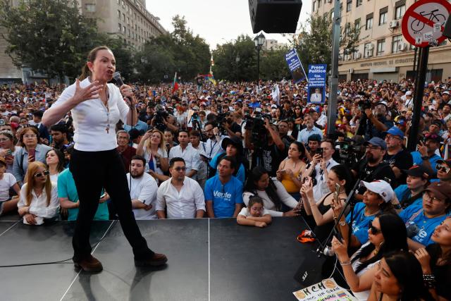 Venezuelan opposition leader Maria Corina Machado gestures as she speaks to members of the Venezuelan community during an encounter in Chile at Almagro Square in Santiago on March 12, 2026. Machado travelled to Chile to attend Chile's President Jose Antonio Kast's inauguration. (Photo by Raul BRAVO / AFP)