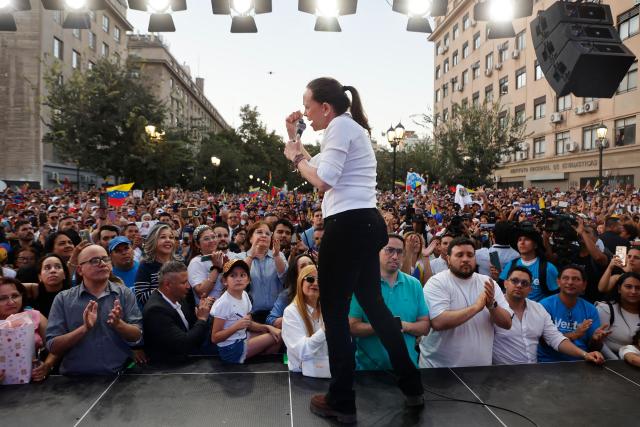 Venezuelan opposition leader Maria Corina Machado gestures as she speaks to members of the Venezuelan community during an encounter in Chile at Almagro Square in Santiago on March 12, 2026. Machado travelled to Chile to attend Chile's President Jose Antonio Kast's inauguration. (Photo by Raul BRAVO / AFP)