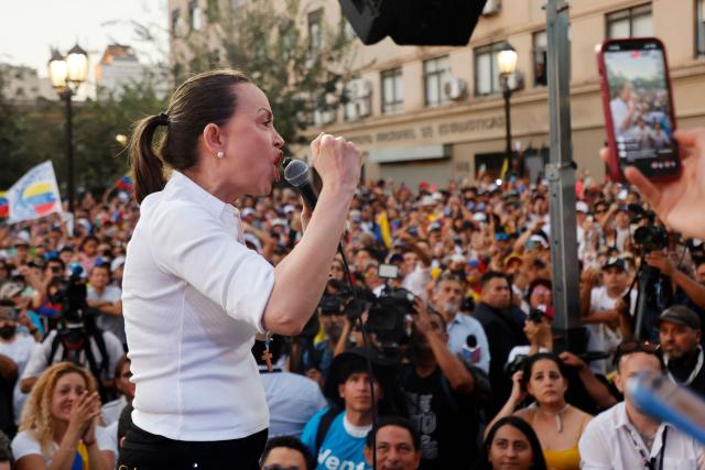 Venezuelan opposition leader Maria Corina Machado gestures as she speaks to members of the Venezuelan community during an encounter in Chile at Almagro Square in Santiago on March 12, 2026. Machado travelled to Chile to attend Chile's President Jose Antonio Kast's inauguration. (Photo by Raul BRAVO / AFP)