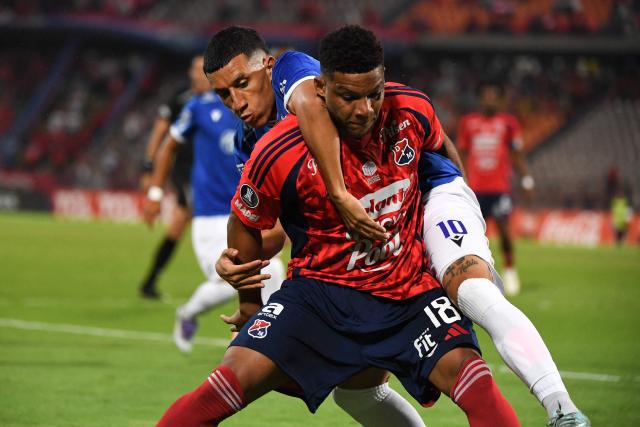 Independiente Medellin's defender #18 Frank Fabra (front) and Juventud's forward #10 Bruno Larregui fight for the ball during the Copa Libertadores phase three second-leg football match between Colombia's Independiente Medellin and Uruguay's Juventud at the Atanasio Girardot Stadium in Medellin, Colombia on March 12, 2026. (Photo by Jaime SALDARRIAGA / AFP)