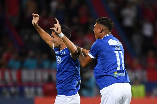 Juventud's defender #24 Federico Barrandeguy (L) celebrates with teammate midfielder #11 Pablo Lago after scoring his team's first goal during the Copa Libertadores phase three second-leg football match between Colombia's Independiente Medellin and Uruguay's Juventud at the Atanasio Girardot Stadium in Medellin, Colombia on March 12, 2026. (Photo by Jaime SALDARRIAGA / AFP)