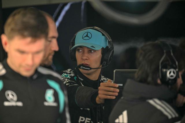 Mercedes' British driver George Russell (C) looks on before a practice session ahead of the Formula One Chinese Grand Prix at the Shanghai International Circuit in Shanghai on March 13, 2026. (Photo by HECTOR RETAMAL / AFP)