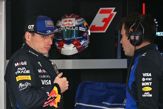 Red Bull Racing's Dutch driver Max Verstappen (L) prepares before a practice session ahead of the Formula One Chinese Grand Prix at the Shanghai International Circuit in Shanghai on March 13, 2026. (Photo by HECTOR RETAMAL / AFP)