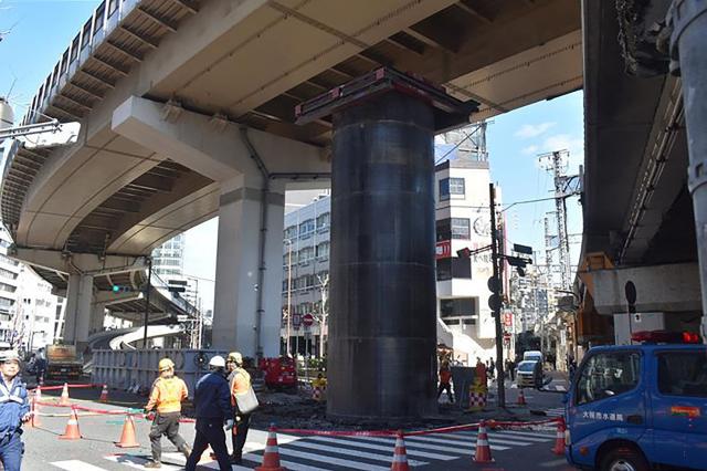 This photo taken on March 11, 2026 shows a scene at a sewage construction site in Osaka City, where a steel pipe has been pushed upward, protruding more than 10 meters above ground level. A large steel column that suddenly jutted out from the ground near highways in Japan's western city of Osaka is causing headache to drivers and the local authorities. (Photo by JIJI PRESS / AFP) / Japan OUT
