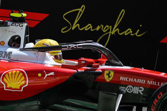 Ferrari's British driver Lewis Hamilton arrives to the pit lane during a practice session ahead of the Formula One Chinese Grand Prix at the Shanghai International Circuit in Shanghai on March 13, 2026. (Photo by Hector RETAMAL / AFP)