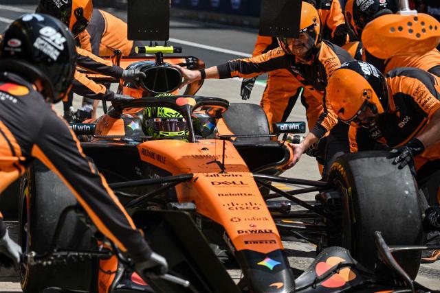 Mechanics work on the car of McLaren's British driver Lando Norris during a practice session ahead of the Formula One Chinese Grand Prix at the Shanghai International Circuit in Shanghai on March 13, 2026. (Photo by Hector RETAMAL / AFP)