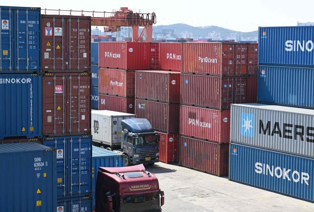 Cargo containers are seen at an Inland Container Depot (ICD) terminal in Uiwang on March 13, 2026. (Photo by Jung Yeon-je / AFP)