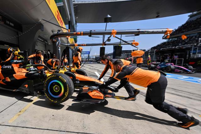 McLaren's British driver Lando Norris arrives to the pit lane during a practice session ahead of the Formula One Chinese Grand Prix at the Shanghai International Circuit in Shanghai on March 13, 2026. (Photo by Hector RETAMAL / AFP)