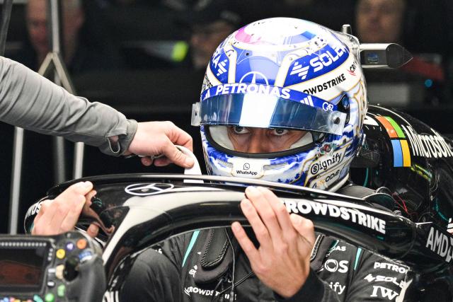 Mercedes’ British driver George Russell prepares before a practice session ahead of the Formula One Chinese Grand Prix at the Shanghai International Circuit in Shanghai on March 13, 2026. (Photo by Hector RETAMAL / AFP)