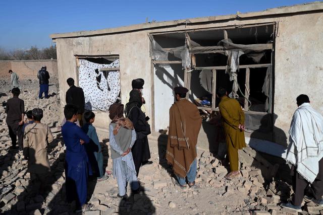Afghans inspect a damaged house at the site of an overnight Pakistan airstrike, at a residential area in Pol-e-Charkhi on the outskirts of Kabul on March 13, 2026. Afghan authorities said on March 13 that Pakistan had carried out new strikes on Kabul and border provinces, killing four people in the capital. (Photo by Wakil KOHSAR / AFP)