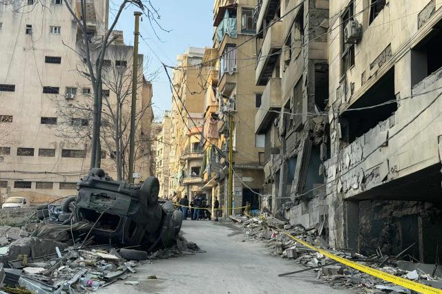 Yellow tape is rolled out as a preventative safety measure the day after an Israeli airstrike targeted a building in Beirut’s Bashoura neighborhood on March 13, 2026. Israel continued striking Beirut as it threatened to expand operations and seize territory in Lebanon if the militant group Hezbollah did not stop its attacks. (Photo by IBRAHIM AMRO / AFP)