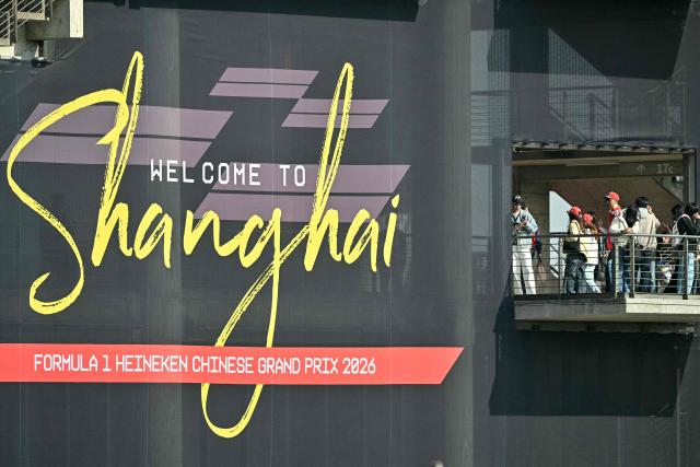 Spectators wait for the sprint qualifying session ahead of the Formula One Chinese Grand Prix at the Shanghai International Circuit in Shanghai on March 13, 2026. (Photo by HECTOR RETAMAL / AFP)
