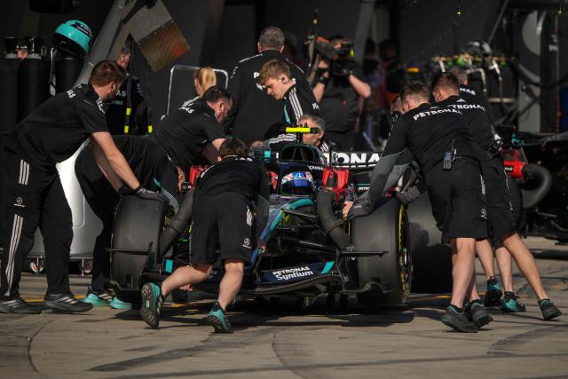Mechanics push the car of Mercedes' Italian driver Kimi Antonelli in the pits during the sprint qualifying session ahead of the Formula One Chinese Grand Prix at the Shanghai International Circuit in Shanghai on March 13, 2026. (Photo by Andy WONG / POOL / AFP)