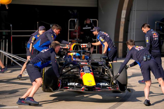 Mechanics push the car of Red Bull Racing's Dutch driver Max Verstappen in the pits during the sprint qualifying session ahead of the Formula One Chinese Grand Prix at the Shanghai International Circuit in Shanghai on March 13, 2026. (Photo by Andy Wong / POOL / AFP)