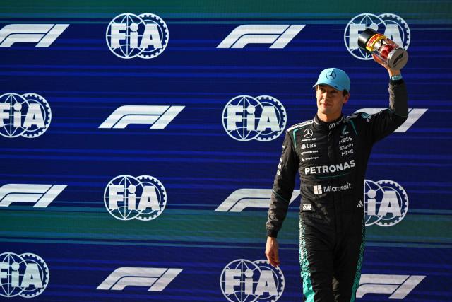 Mercedes' British driver George Russell celebrates getting pole position in the sprint qualifying session ahead of the Formula One Chinese Grand Prix at the Shanghai International Circuit in Shanghai on March 13, 2026. (Photo by JADE GAO / AFP)