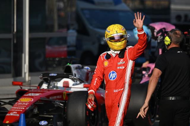 Ferrari's British driver Lewis Hamilton waves to fans after the sprint qualifying session ahead of the Formula One Chinese Grand Prix at the Shanghai International Circuit in Shanghai on March 13, 2026. (Photo by JADE GAO / AFP)