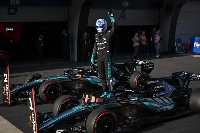 TOPSHOT - Mercedes' British driver George Russell celebrates getting pole position in the sprint qualifying session ahead of the Formula One Chinese Grand Prix at the Shanghai International Circuit in Shanghai on March 13, 2026. (Photo by JADE GAO / AFP)