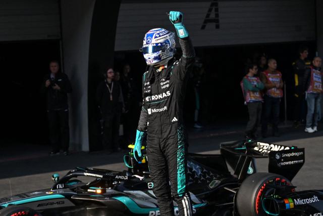 Mercedes' British driver George Russell celebrates getting pole position in the sprint qualifying session ahead of the Formula One Chinese Grand Prix at the Shanghai International Circuit in Shanghai on March 13, 2026. (Photo by JADE GAO / AFP)