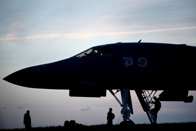 Personnel prepare a US Air Force B-1 Lancer bomber for takeoff at RAF Fairford in south-west England on March 13, 2026. Fairford is one of two bases, along with the Diego Garcia facility in the Indian Ocean, that the UK has given the US permission to use for "specific defensive operations into Iran" to destroy Iranian missiles at source, the British defence minister said in a statement. (Photo by Henry NICHOLLS / AFP)