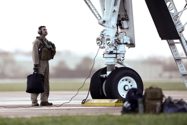 USAF military personnel stand around a US Air Force B-1 Lancer bomber parked on the tarmac before takeoff in south-west England on March 13, 2026. Fairford is one of two bases, along with the Diego Garcia facility in the Indian Ocean, that the UK has given the US permission to use for "specific defensive operations into Iran" to destroy Iranian missiles at source, the British defence minister said in a statement. (Photo by Henry NICHOLLS / AFP)