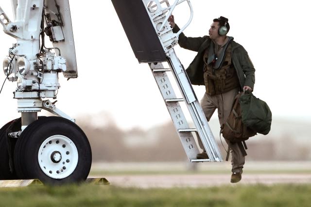 USAF military personnel boards a US Air Force B-1 Lancer bomber for takeoff at RAF Fairford in south-west England on March 13, 2026. Fairford is one of two bases, along with the Diego Garcia facility in the Indian Ocean, that the UK has given the US permission to use for "specific defensive operations into Iran" to destroy Iranian missiles at source, the British defence minister said in a statement. (Photo by Henry NICHOLLS / AFP)