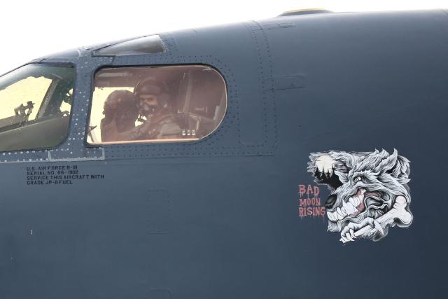 A pilot gestures from inside the cockpit of a US Air Force B-1 Lancer bomber before takeoff at RAF Fairford in south-west England on March 13, 2026. Fairford is one of two bases, along with the Diego Garcia facility in the Indian Ocean, that the UK has given the US permission to use for "specific defensive operations into Iran" to destroy Iranian missiles at source, the British defence minister said in a statement. (Photo by Henry NICHOLLS / AFP)