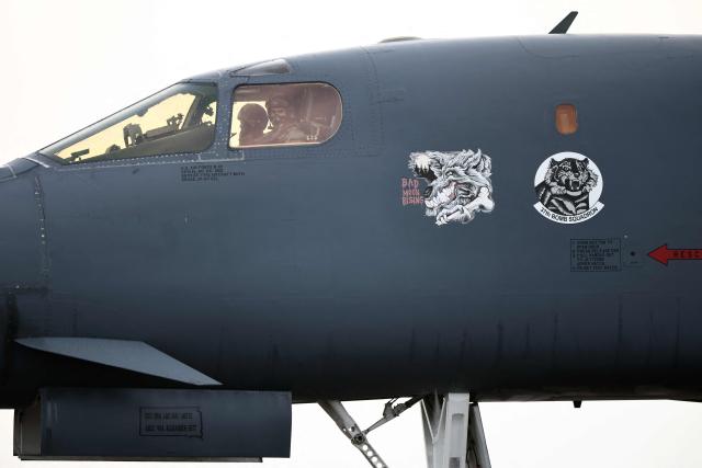 A pilot gestures from inside the cockpit of a US Air Force B-1 Lancer bomber before takeoff at RAF Fairford in south-west England on March 13, 2026. Fairford is one of two bases, along with the Diego Garcia facility in the Indian Ocean, that the UK has given the US permission to use for "specific defensive operations into Iran" to destroy Iranian missiles at source, the British defence minister said in a statement. (Photo by Henry NICHOLLS / AFP)