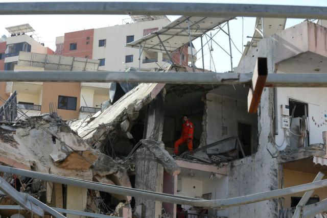 First aid responders evacuate a body from the site of an Israeli airstrike that targeted a neighborhood in the town of Mieh Mieh, some five kilometrs east of the southern lebanese city of Sidon on March 13, 2026. Israel continued striking Beirut as it threatened to expand operations and seize territory in Lebanon if the militant group Hezbollah did not stop its attacks. (Photo by MAHMOUD ZAYYAT / AFP)