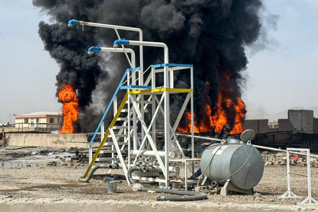 Smoke rises from the site after overnight Pakistani airstrikes hit oil depots for commercial airlines, near the Kandahar airport in the Daman district of Kandahar province on March 13, 2026. Afghan authorities said on March 13 that Pakistan attacks on Kabul and border provinces killed four people in the capital and two in the east, the latest deadly clashes in the long-running conflict. (Photo by AFP)