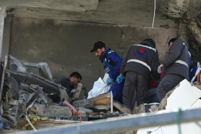 TOPSHOT - First aid responders evacuate a body from the site of an Israeli airstrike that targeted a neighborhood in the town of Mieh Mieh, some five kilometers east of the southern Lebanese city of Sidon on March 13, 2026. Israel continued striking Beirut as it threatened to expand operations and seize territory in Lebanon if the militant group Hezbollah did not stop its attacks. (Photo by MAHMOUD ZAYYAT / AFP)