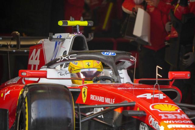 Ferrari's British driver Lewis Hamilton sits in his car in the pits during the sprint qualifying session ahead of the Formula One Chinese Grand Prix at the Shanghai International Circuit in Shanghai on March 13, 2026. (Photo by Andy WONG / POOL / AFP)