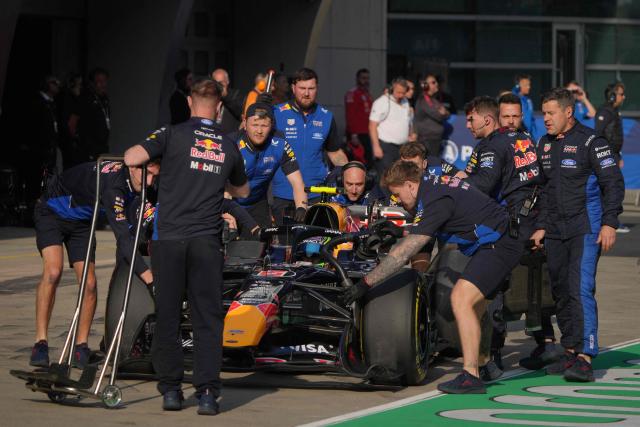 Mechanics push the car of Red Bull Racing's French driver Isack Hadjar in the pits during the sprint qualifying session ahead of the Formula One Chinese Grand Prix at the Shanghai International Circuit in Shanghai on March 13, 2026. (Photo by Andy WONG / POOL / AFP)