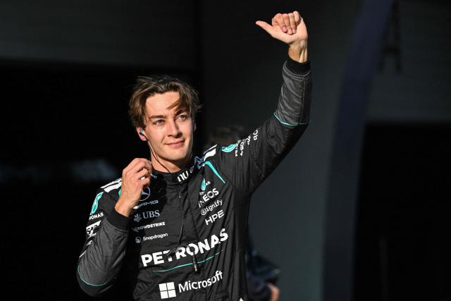Mercedes' British driver George Russell celebrates after getting pole position in the sprint qualifying session ahead of the Formula One Chinese Grand Prix at the Shanghai International Circuit in Shanghai on March 13, 2026. (Photo by Hector RETAMAL / AFP)