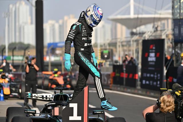 Mercedes' British driver George Russell gets off the car after getting pole position in the sprint qualifying session ahead of the Formula One Chinese Grand Prix at the Shanghai International Circuit in Shanghai on March 13, 2026. (Photo by Hector RETAMAL / AFP)