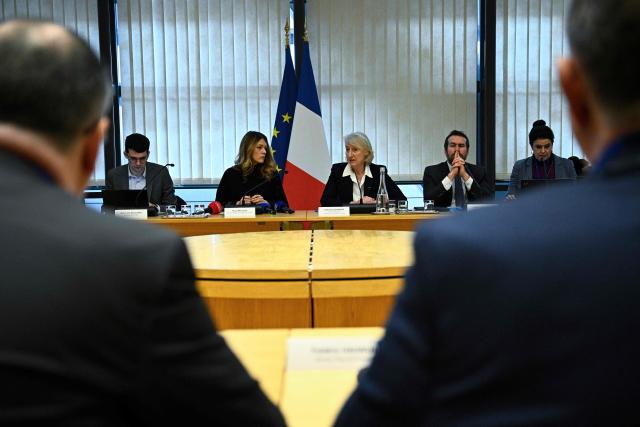 France's Government Spokesperson Maud Bregeon (C-L) listens to France’s junior Minister in charge of the sea and fisheries Catherine Chabaud (C-R) addressing the audience during a meeting with representatives of the fishing industry, banking institutions and energy companies regarding the international situation at the French Economy and Finance Ministry in Paris on March 13, 2026. In response to Bercy’s overtures, the pledge by several retailers to ease French consumers’ bills was already in serious trouble on March 12, 2026, following a fresh rise in oil prices amid the war in the Middle East. (Photo by JULIEN DE ROSA / AFP)