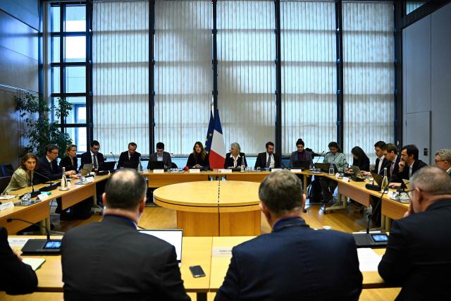 France's Government Spokesperson Maud Bregeon (C-L) and France’s junior Minister in charge of the sea and fisheries Catherine Chabaud (C-R) hold a meeting with representatives of the fishing industry, banking institutions and energy companies regarding the international situation at the French Economy and Finance Ministry in Paris on March 13, 2026. In response to Bercy’s overtures, the pledge by several retailers to ease French consumers’ bills was already in serious trouble on March 12, 2026, following a fresh rise in oil prices amid the war in the Middle East. (Photo by JULIEN DE ROSA / AFP)