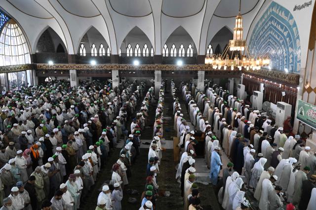 Muslim devotees offer their last Friday prayers of the Islamic holy fasting month of Ramadan, at Data Darbar mosque in Lahore on March 13, 2026. (Photo by Arif ALI / AFP)