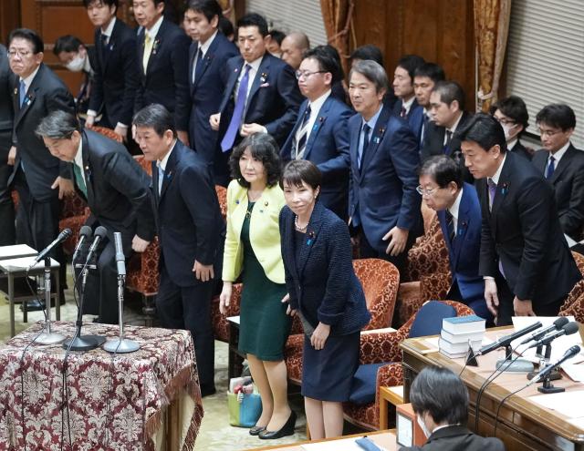 Japan's Prime Minister Sanae Takaichi (front C) and cabinet ministers bow after the government's fiscal 2026 budget bill was approved by the Budget Committee of House of Representatives at Parliament in Tokyo on March 13, 2026. (Photo by JIJI PRESS / AFP) / Japan OUT