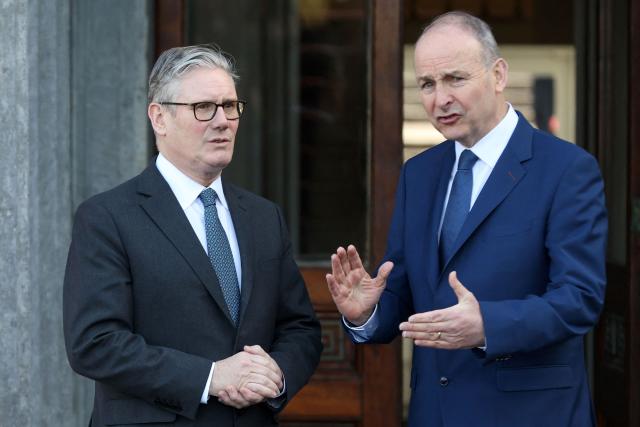Britain's Prime Minister Keir Starmer is greeted by his his Irish counterpart Michael Martin (R) ahead of a plenary session at Fota house in Cork, Ireland, on March 13, 2026, as part of a two-day UK-Ireland summit. (Photo by Paul Faith / AFP)