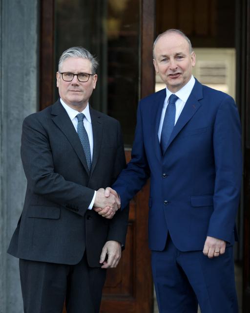 Britain's Prime Minister Keir Starmer is greeted by his his Irish counterpart Michael Martin (R) ahead of a plenary session at Fota house in Cork, Ireland, on March 13, 2026, as part of a two-day UK-Ireland summit. (Photo by Paul Faith / AFP)