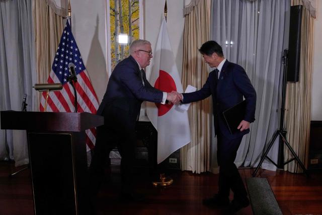 George Glass, US Ambassador to Japan, and Japan's Vice Minister of Economy, Trade and Industry Kenji Yamada shake hands at the reception of the Indo-Pacific Energy Security Ministerial and Business Forum at the US ambassador's residence in Tokyo March 13, 2026. (Photo by Eugene Hoshiko / POOL / AFP)
