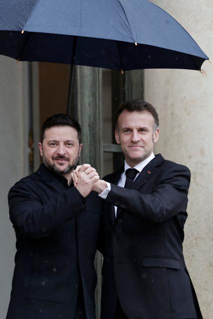 France's President Emmanuel Macron (R) welcomes Ukraine's President Volodymyr Zelensky before a meeting at The Elysee Presidential Palace in Paris on March 13, 2026. (Photo by STEPHANE DE SAKUTIN / AFP)