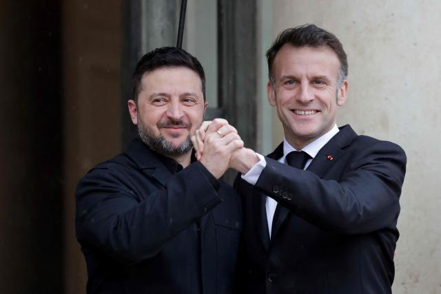 France's President Emmanuel Macron (R) welcomes welcomes Ukraine's President Volodymyr Zelensky before a meeting at The Elysee Presidential Palace in Paris on March 13, 2026. (Photo by Ludovic MARIN / AFP)